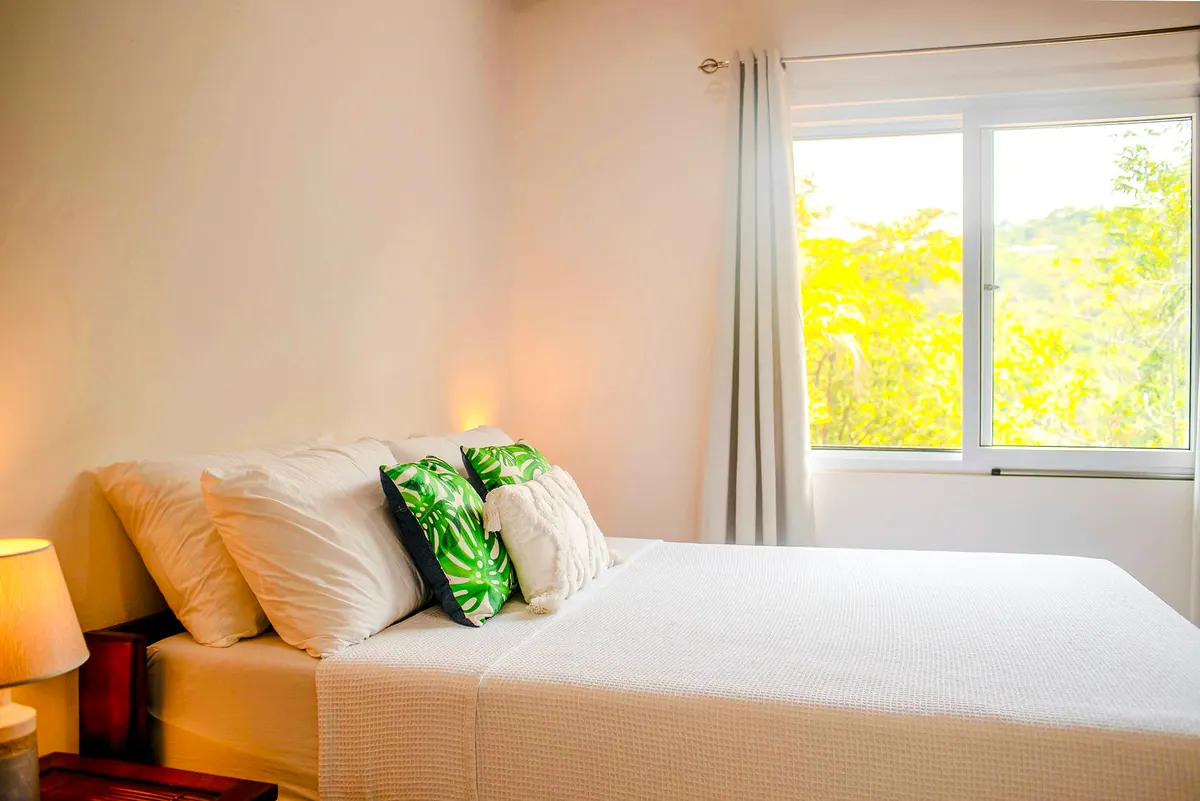 Second bedroom bed with fresh linens and cozy pillows