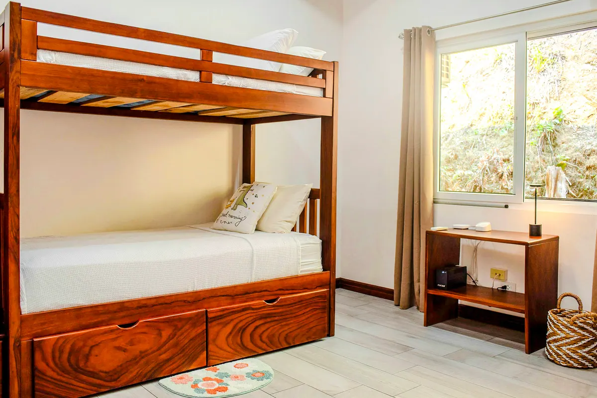 Third bedroom with custom wood bunk beds and storage