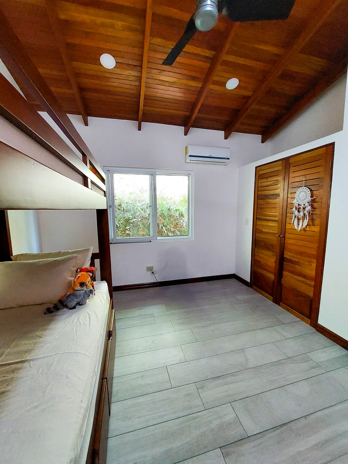 Bunk room with ladder access and cozy sleeping nooks