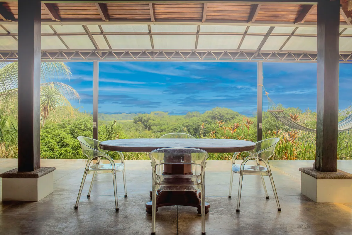 Outdoor dining area with panoramic jungle and sky view
