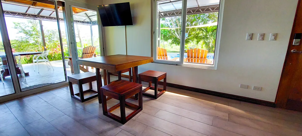 Indoor dining area with elegant table setting and jungle views