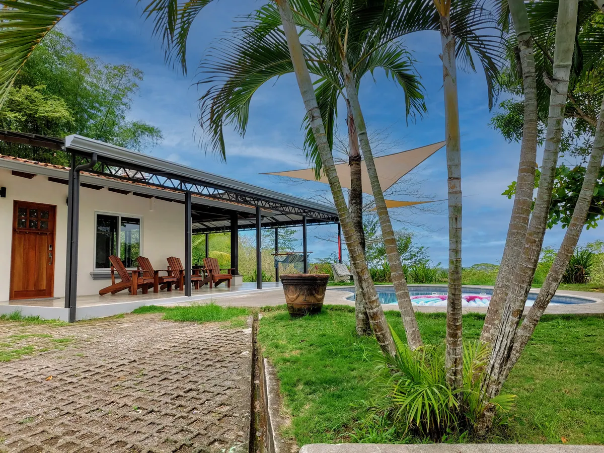 Private driveway entrance to Villa Hermosa with tropical landscaping