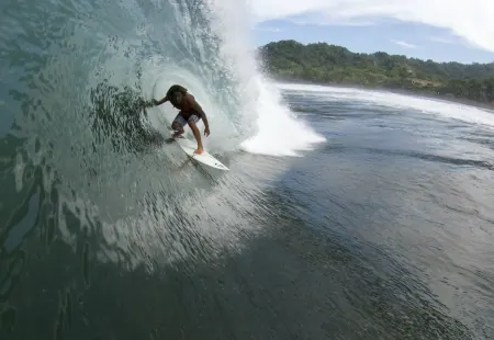 Surfer riding inside a barrel wave at Playa Hermosa World Surfing Reserve