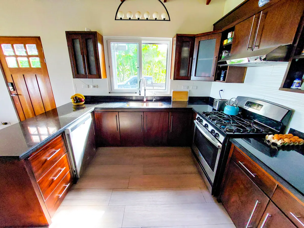 Fully equipped kitchen with dark hardwood cabinets and granite countertops
