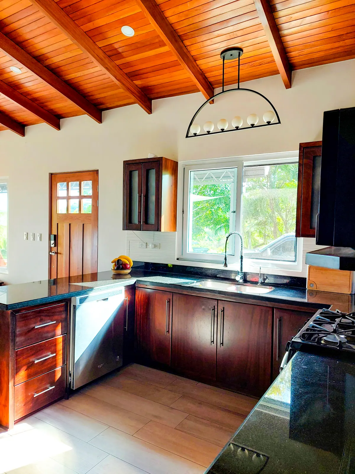 Full kitchen overview showing island, storage, and cooking area