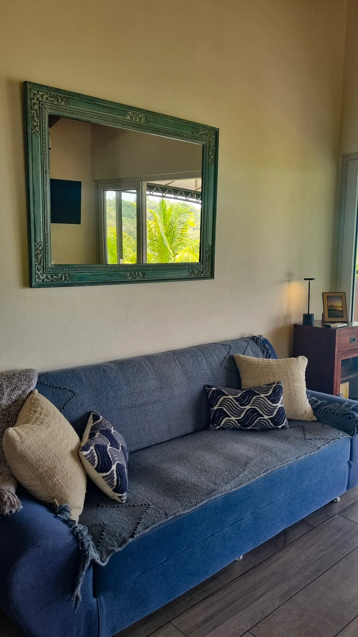 Comfortable living room seating area with modern couch and tropical decor