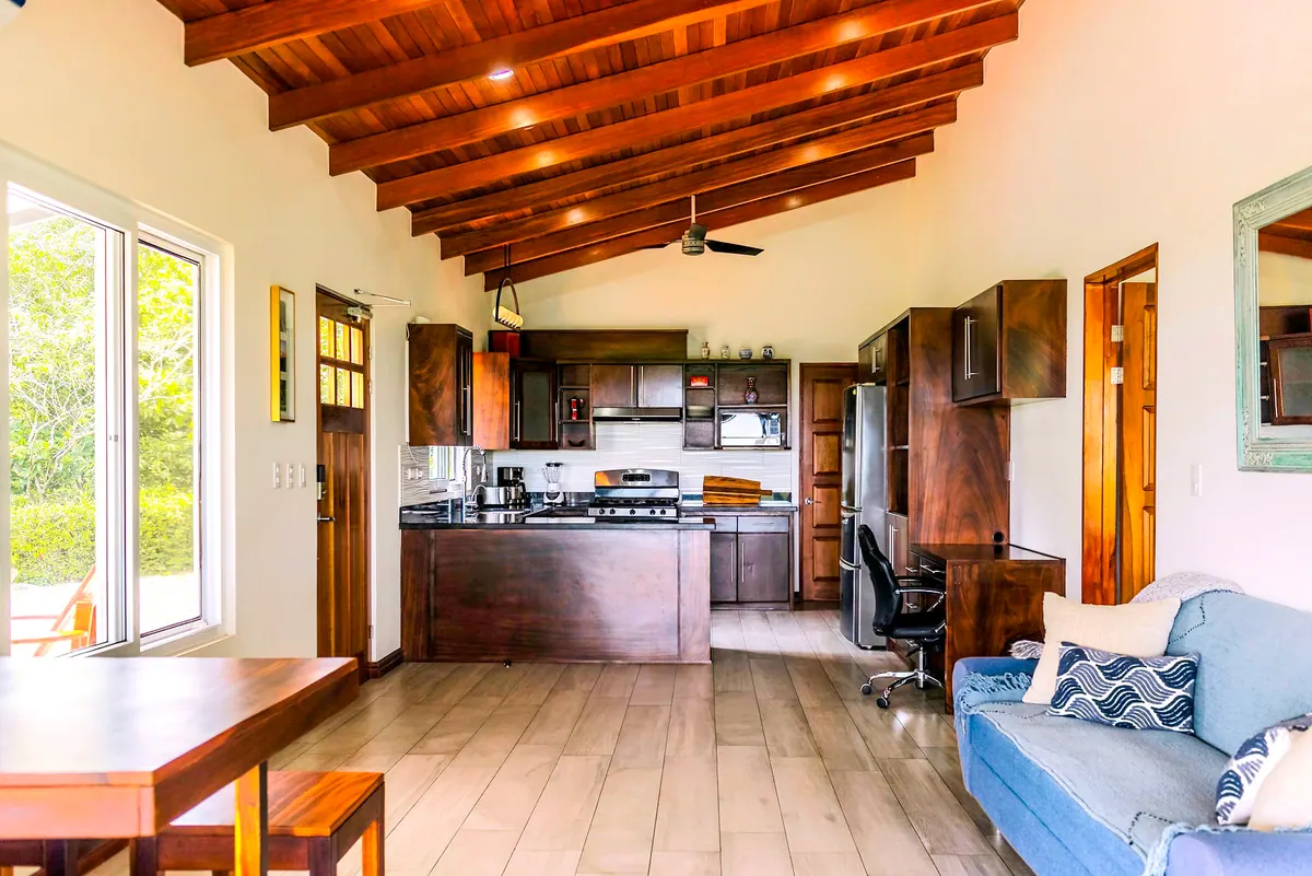 Spacious main living area with vaulted wood ceiling and natural light