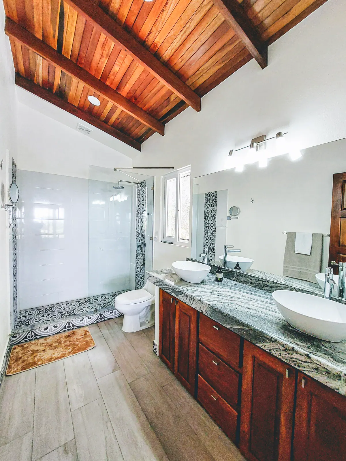 Spacious master bathroom with modern fixtures and natural stone
