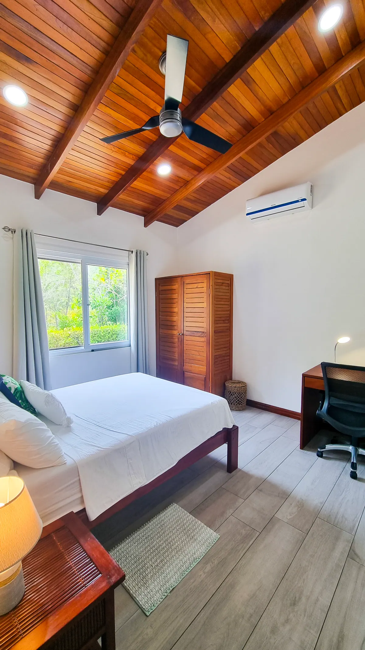 Master bedroom with vaulted wood ceiling, ergonomic desk, ceiling fan, and AC