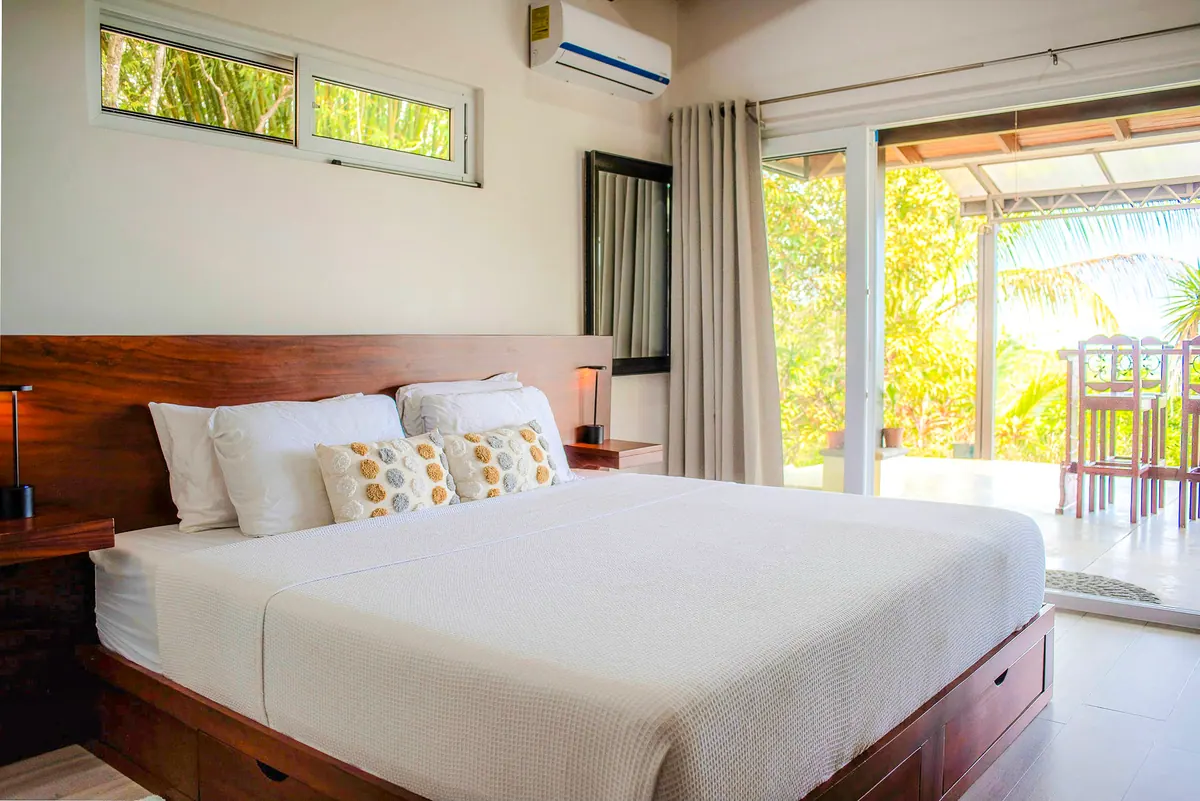 Luxurious master bedroom with king bed and high wood ceiling