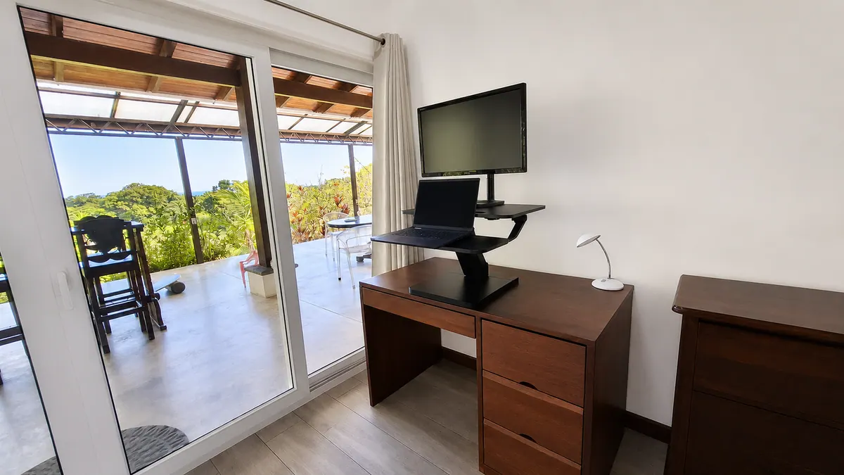 Adjustable standing desk in master bedroom for remote workers