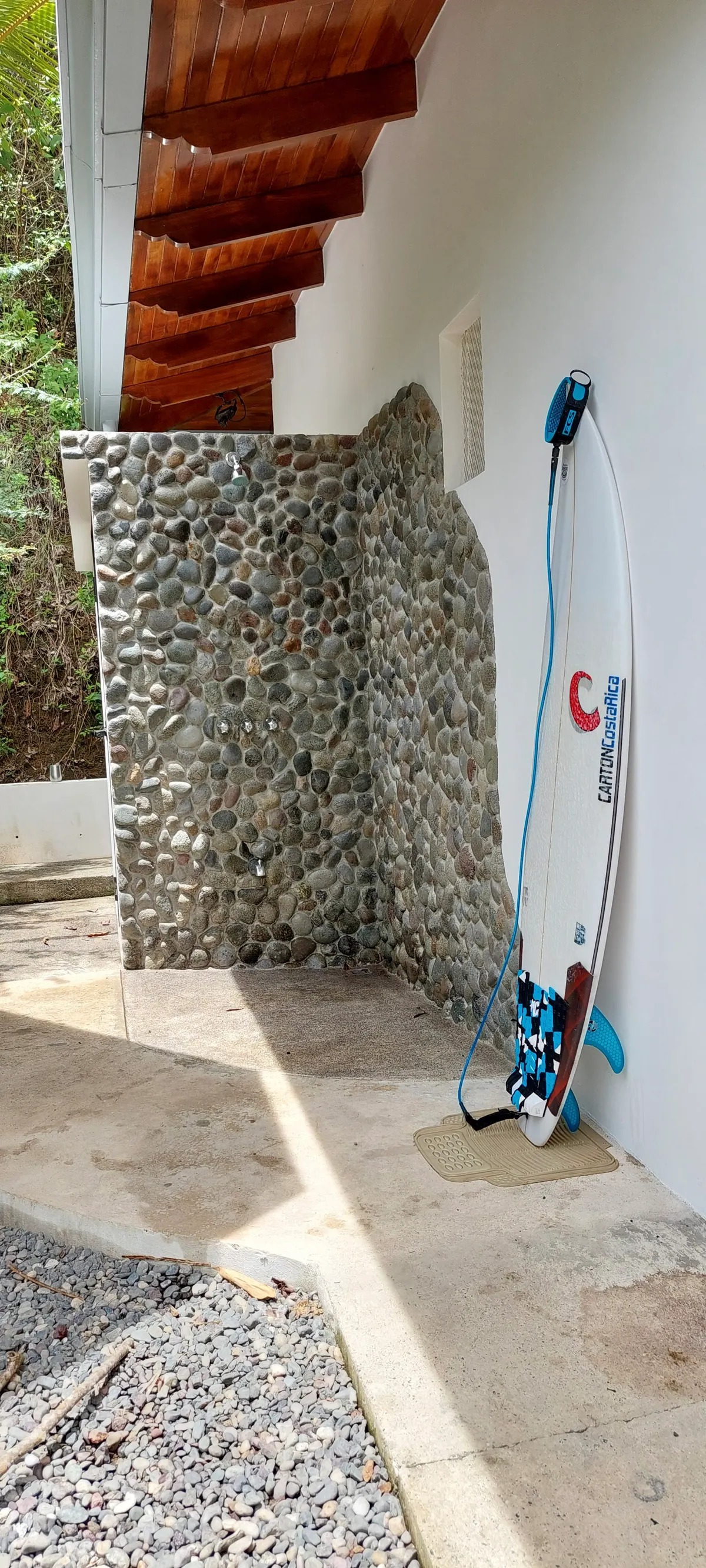 Refreshing outdoor shower surrounded by tropical plants