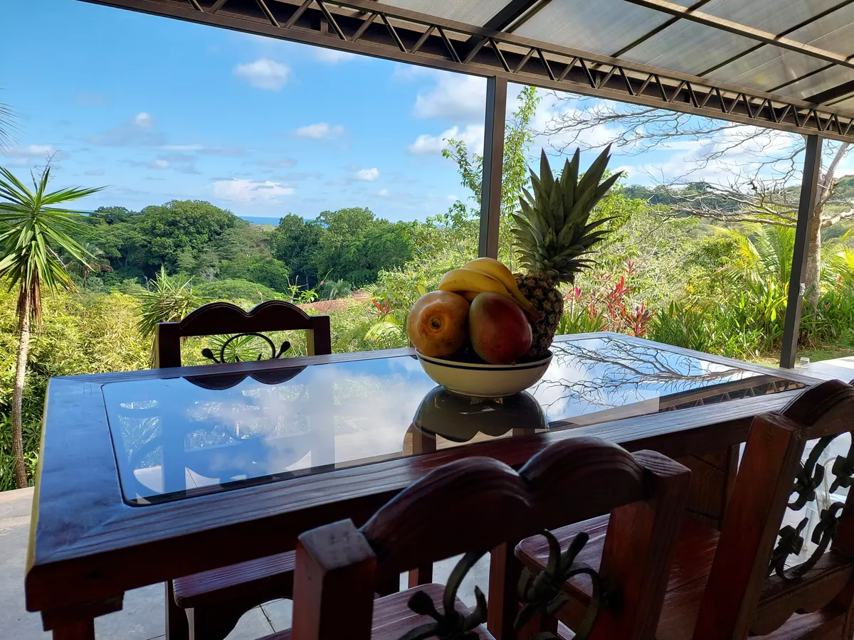 Morning breakfast table on the patio with fresh tropical fruits