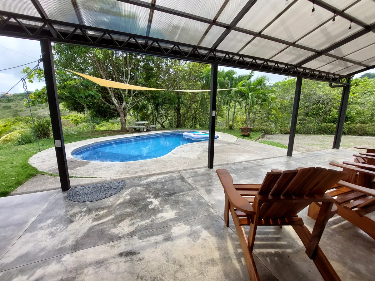 Patio area connecting to the pool with seamless indoor-outdoor flow